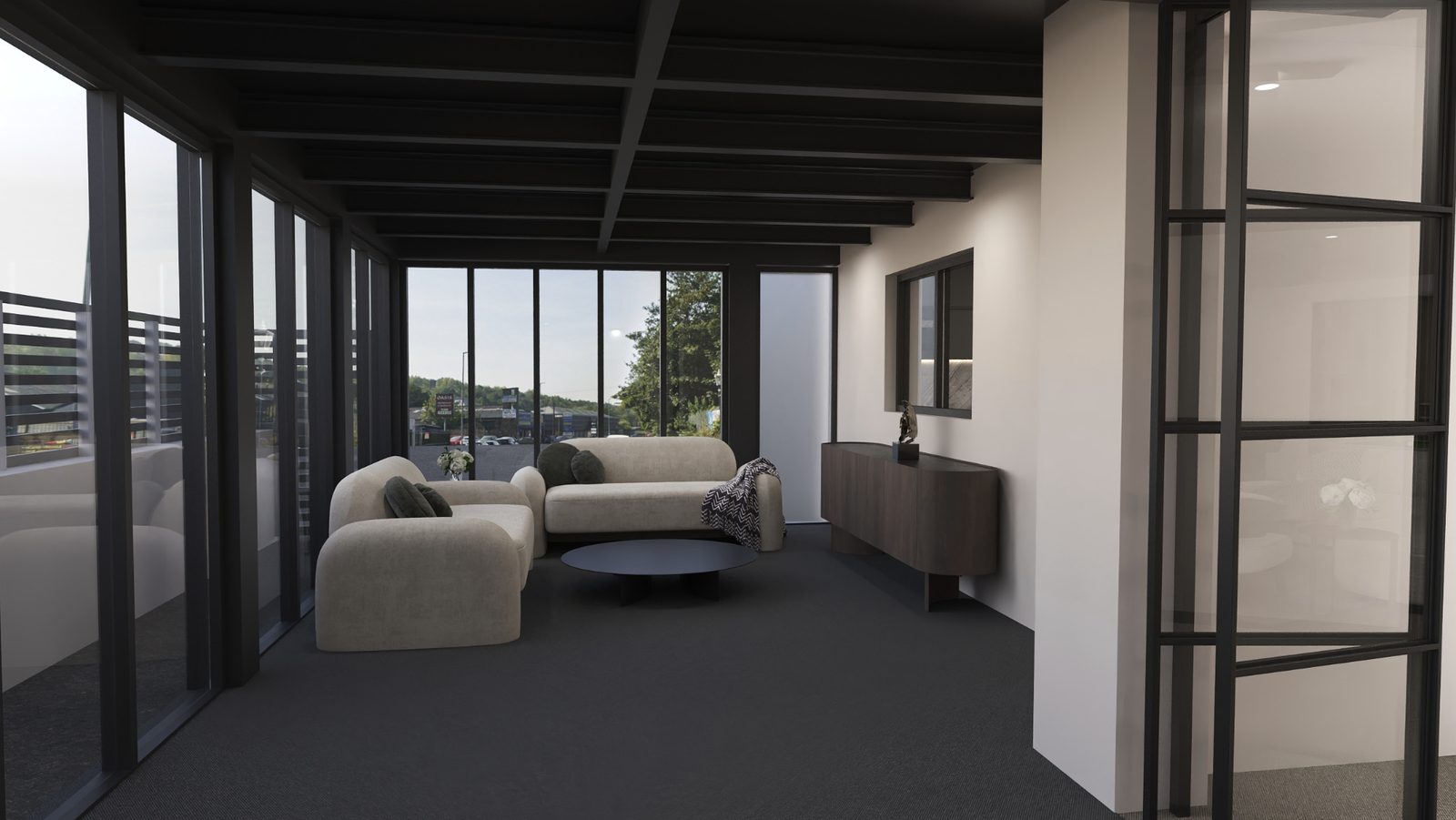 A lounge with floor-to-ceiling windows on three sides, two cream sofas and a round coffee table.