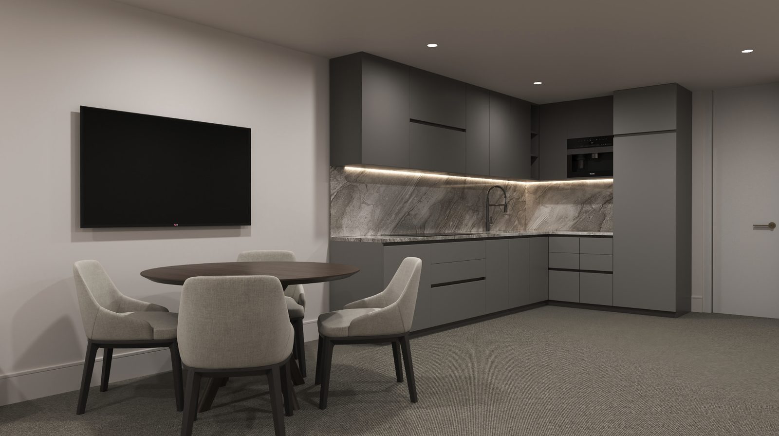 A kitchen with grey units and under-cabinet lighting, a round table with four chairs, and a wall-mounted television.